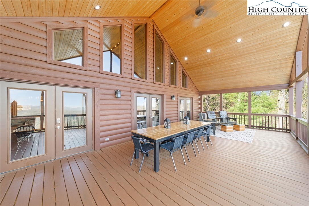 196 Eagle Nest Road Purlear, NC 28665 - Photo 5 of 36 a view of a roof deck with table and chairs with wooden floor
