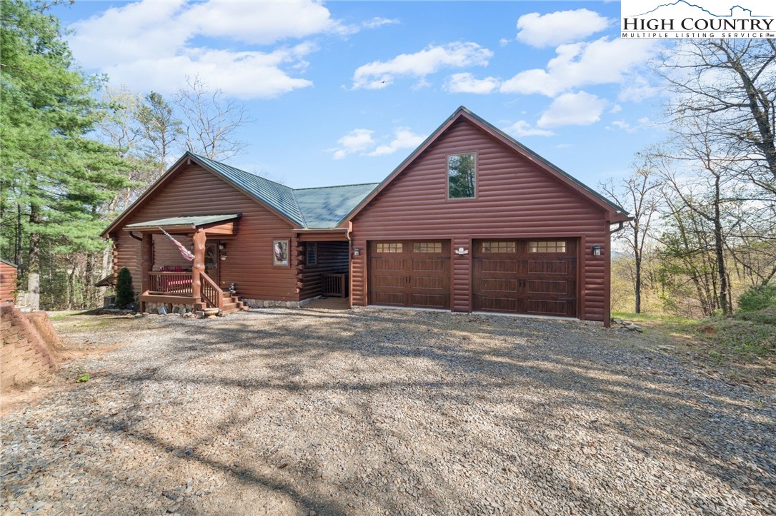 196 Eagle Nest Road Purlear, NC 28665 - Photo 6 of 36 a front view of a house with a yard and garage