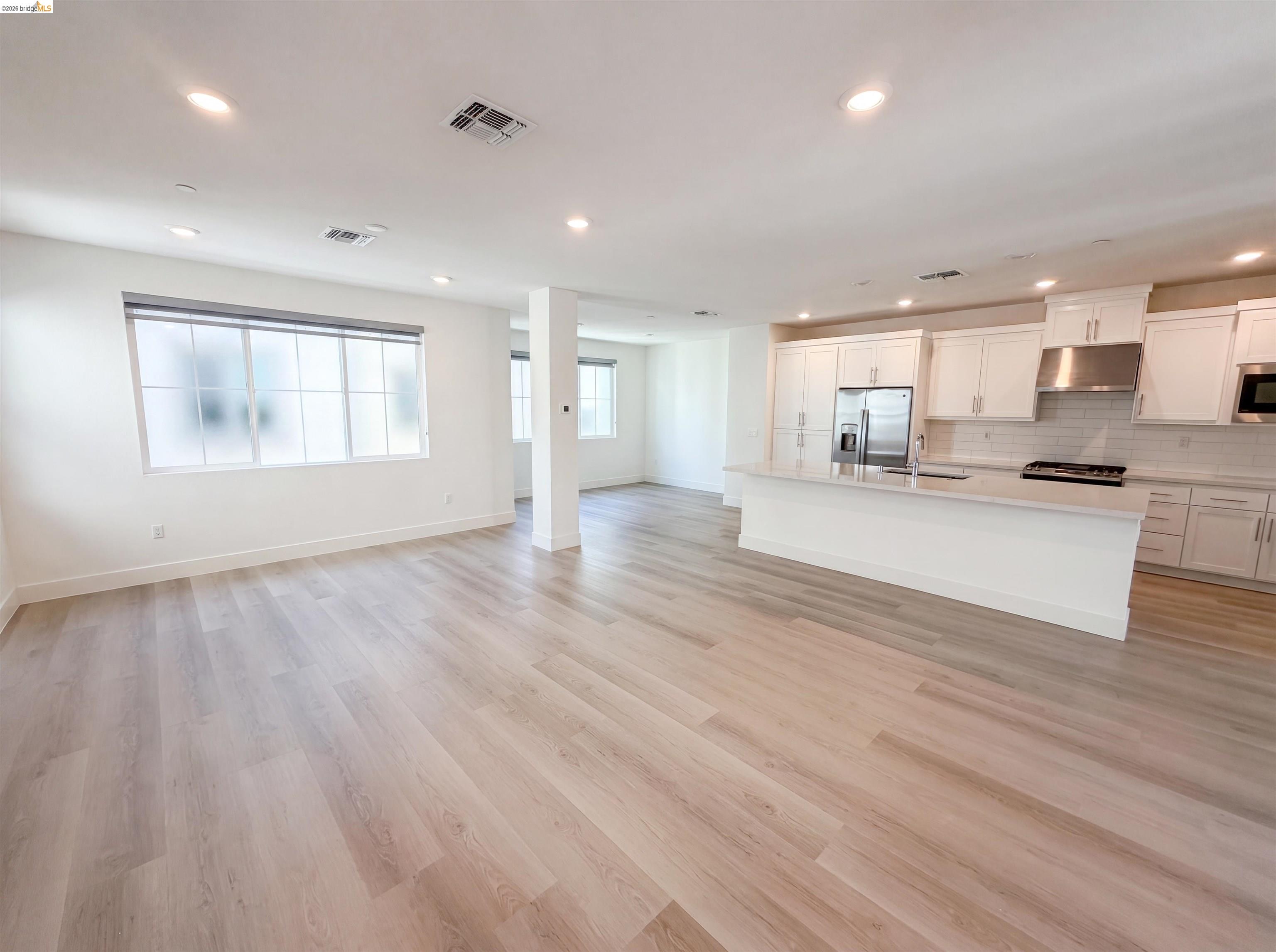 9034 Rudder Way Newark, CA 94560 - Photo 3 of 38 Open-concept living space featuring wood-finish flooring, recessed lighting, and large windows