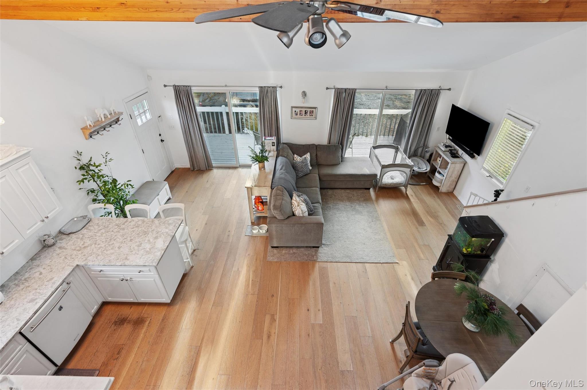6 Shore Road Southampton, NY 11968 - Photo 3 of 15 Living room featuring light wood finished floors and a ceiling fan