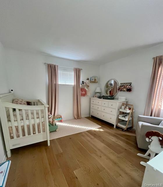6 Shore Road Southampton, NY 11968 - Photo 6 of 15 Bedroom with a crib and light wood finished floors