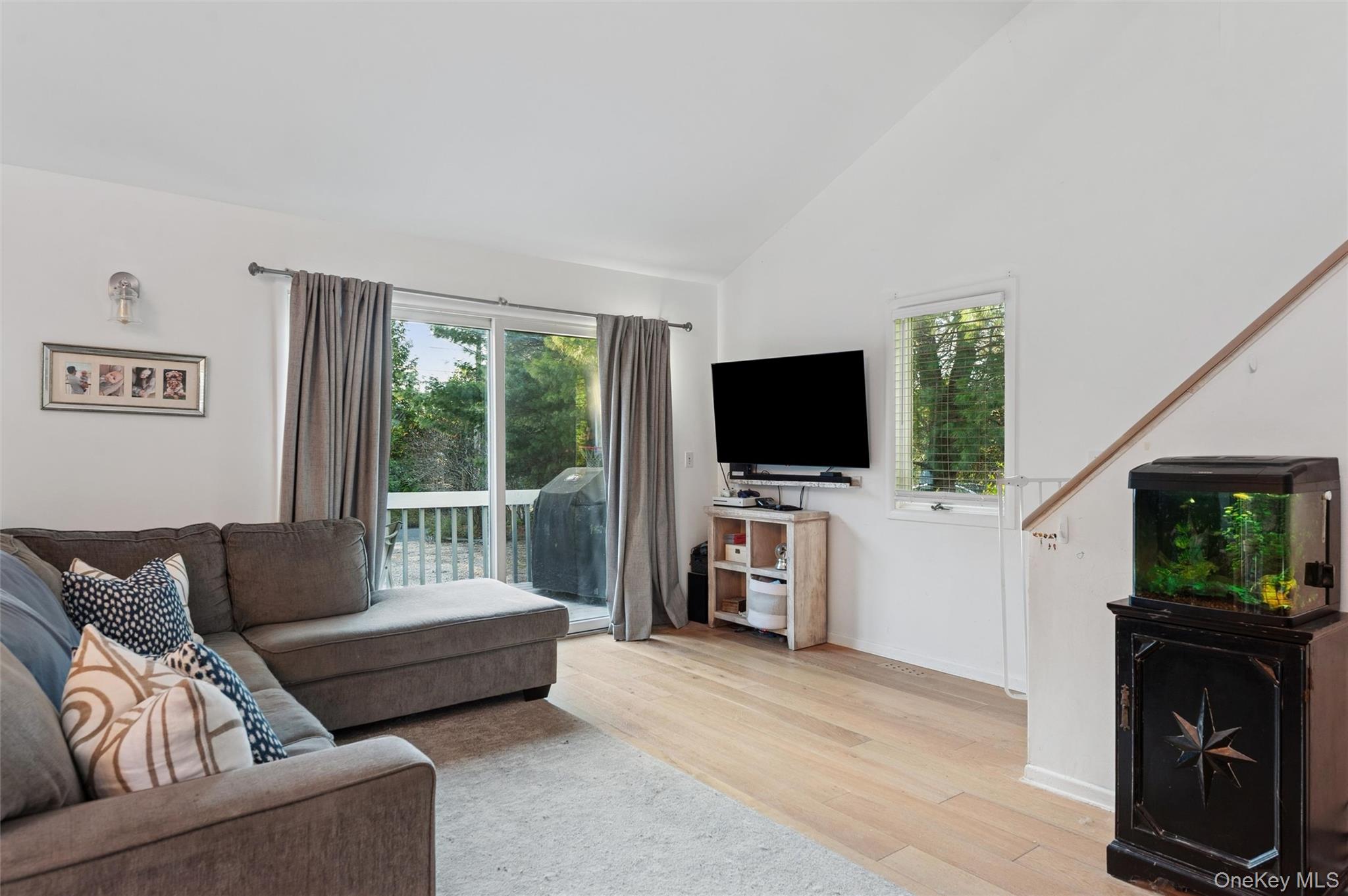6 Shore Road Southampton, NY 11968 - Photo 10 of 15 Living room with light wood-style floors, lofted ceiling, and healthy amount of natural light