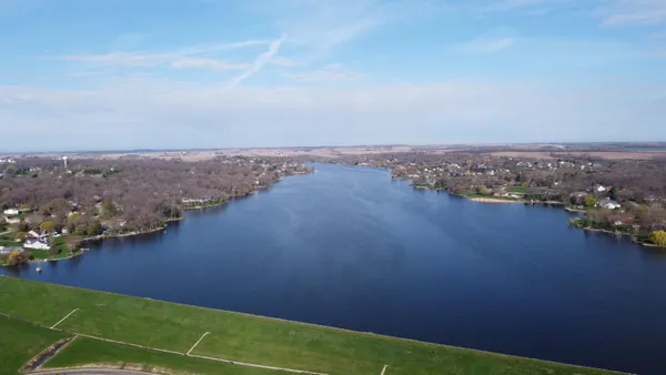 an aerial view of a house with a lake view
