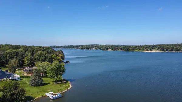 an aerial view of a houses with a lake view