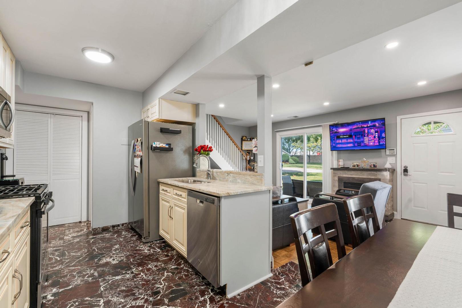 1312 Fall Court, Unit 1312 Wheeling, IL 60090 - Photo 11 of 28 a view of a kitchen with fridge and workspace