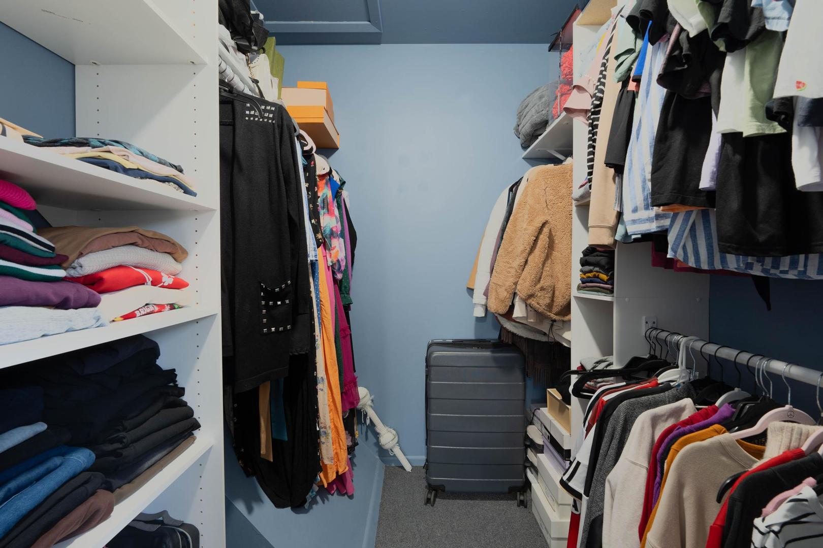 1312 Fall Court, Unit 1312 Wheeling, IL 60090 - Photo 15 of 28 a view of walk in closet with clothes and shoes