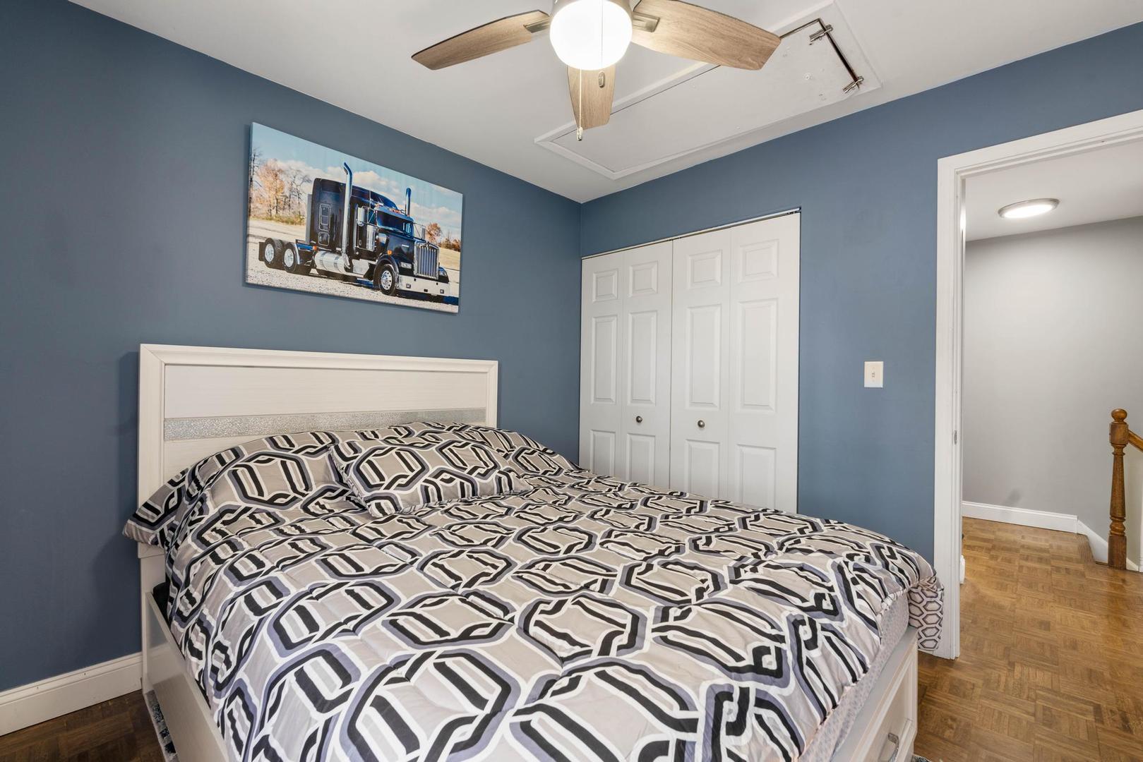 1312 Fall Court, Unit 1312 Wheeling, IL 60090 - Photo 17 of 28 a bedroom with a bed and a chandelier