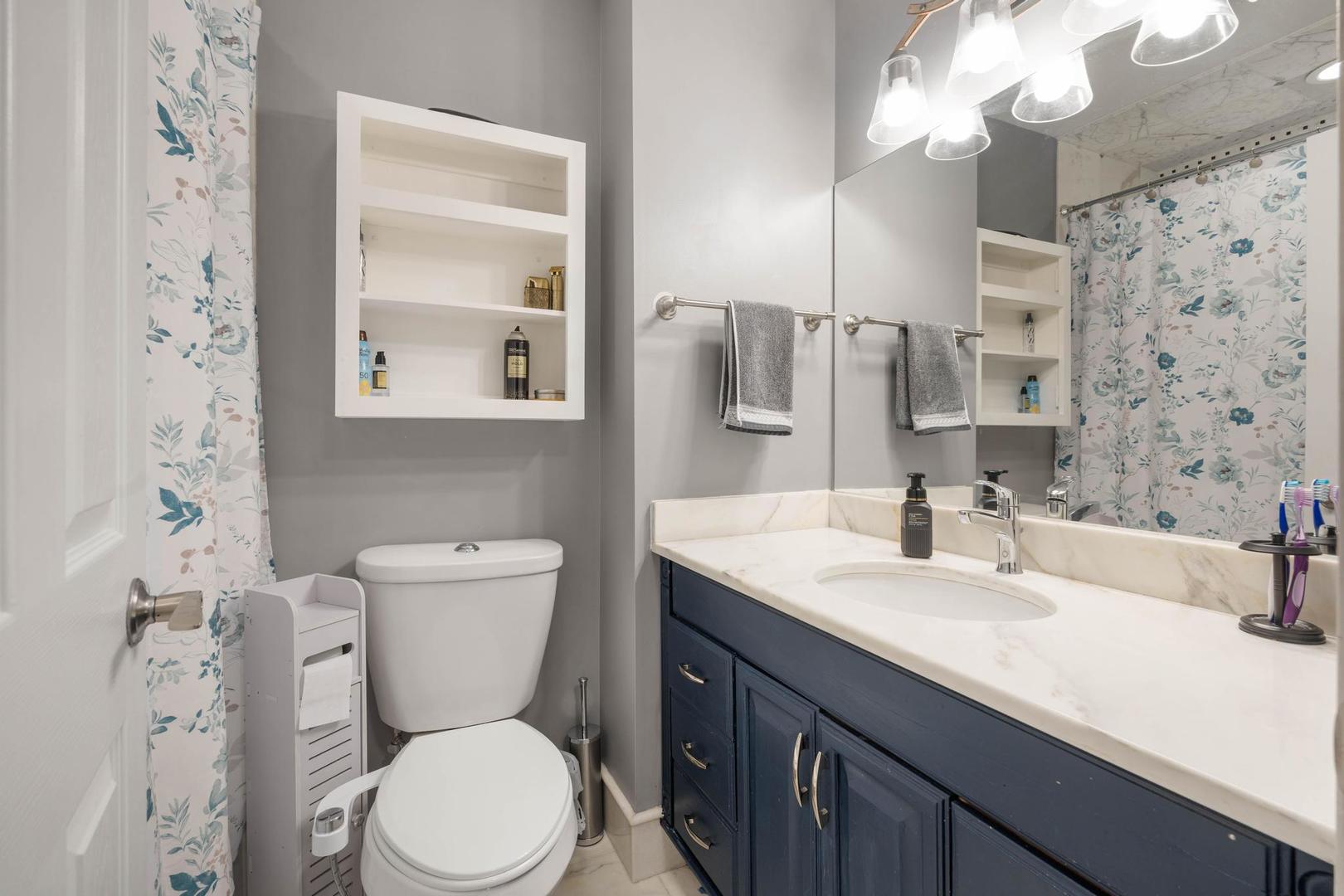 1312 Fall Court, Unit 1312 Wheeling, IL 60090 - Photo 18 of 28 a bathroom with a sink a toilet and a large mirror