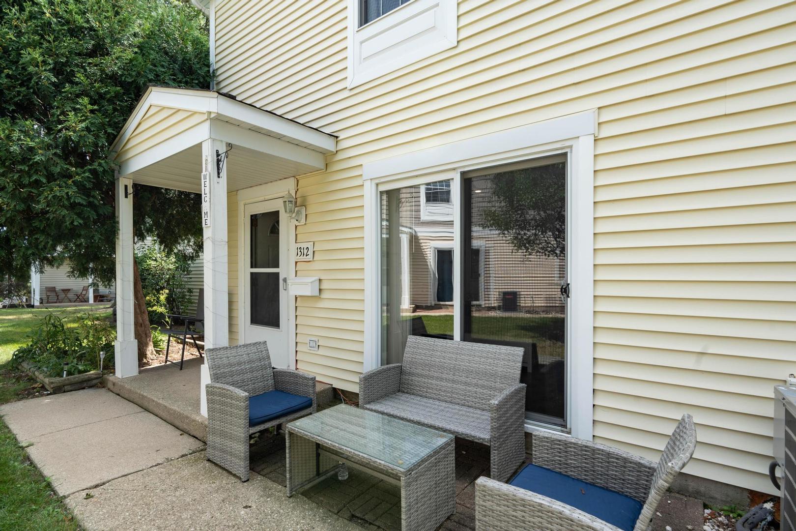 1312 Fall Court, Unit 1312 Wheeling, IL 60090 - Photo 2 of 28 a view of house with wooden deck and furniture