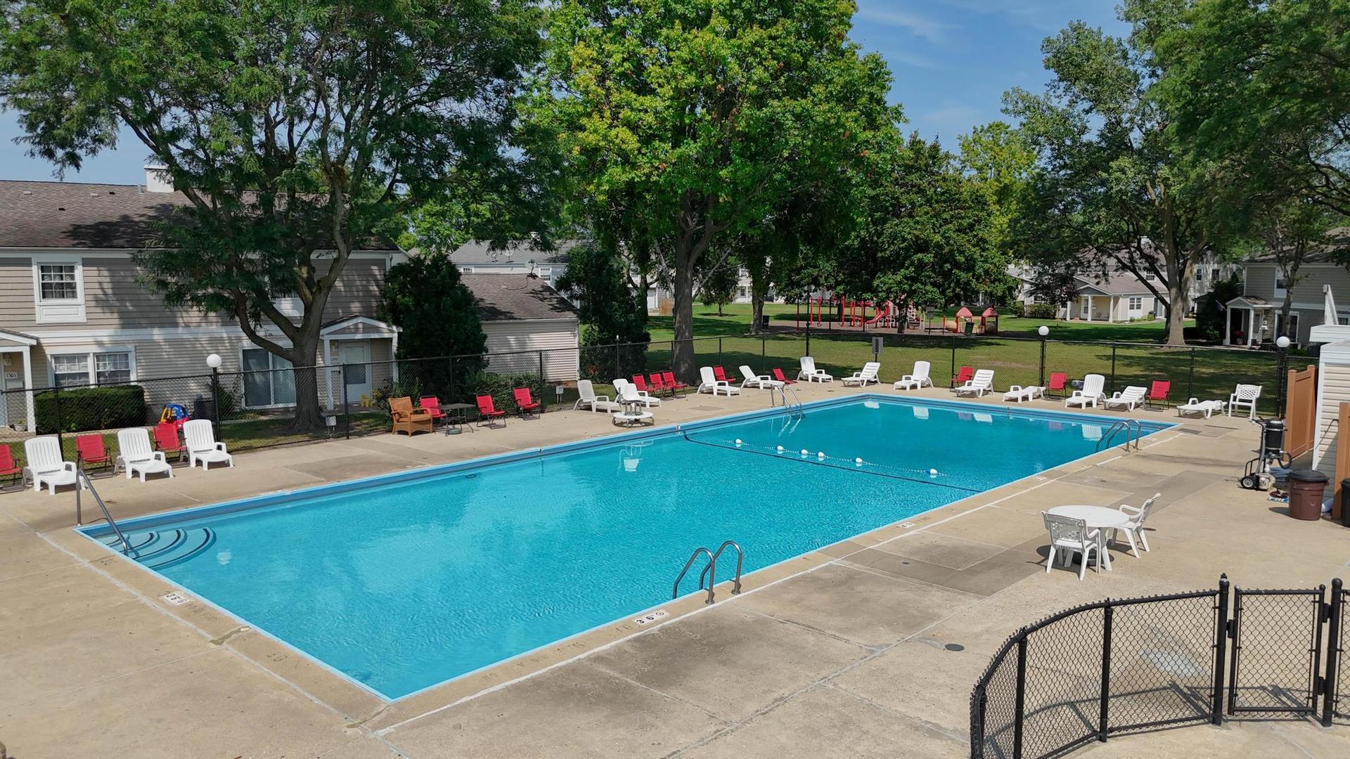 1312 Fall Court, Unit 1312 Wheeling, IL 60090 - Photo 23 of 28 an outdoor space with swimming pool and lounge chair