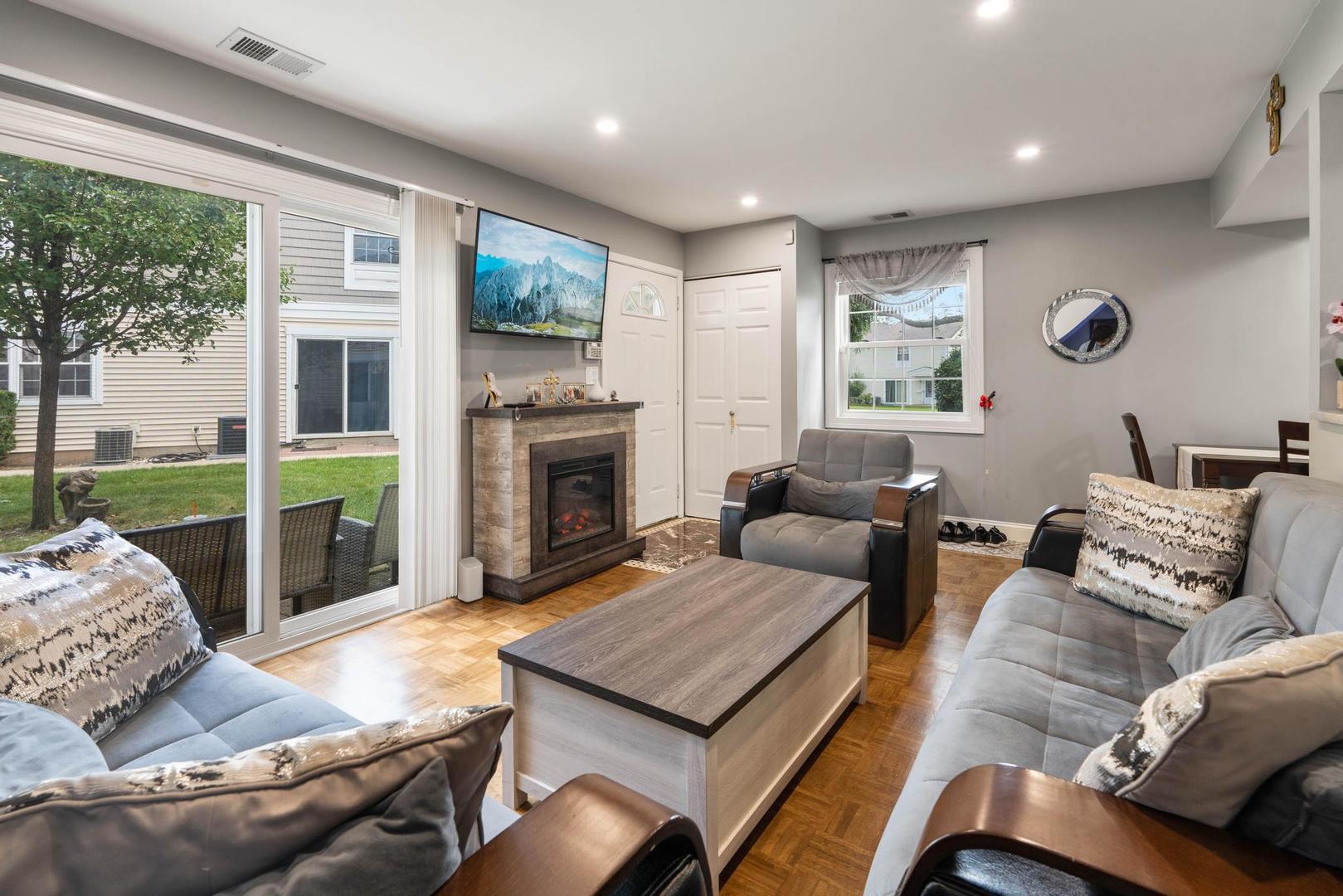 1312 Fall Court, Unit 1312 Wheeling, IL 60090 - Photo 5 of 28 a living room with furniture and a fireplace