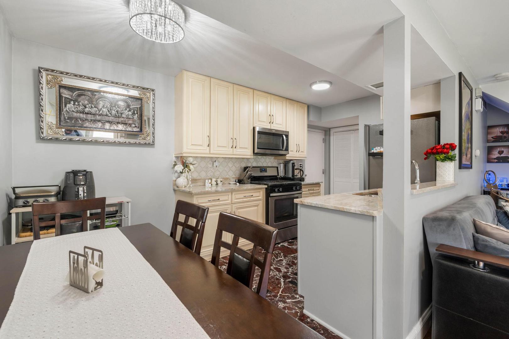 1312 Fall Court, Unit 1312 Wheeling, IL 60090 - Photo 8 of 28 a kitchen with stainless steel appliances granite countertop a refrigerator sink and stove
