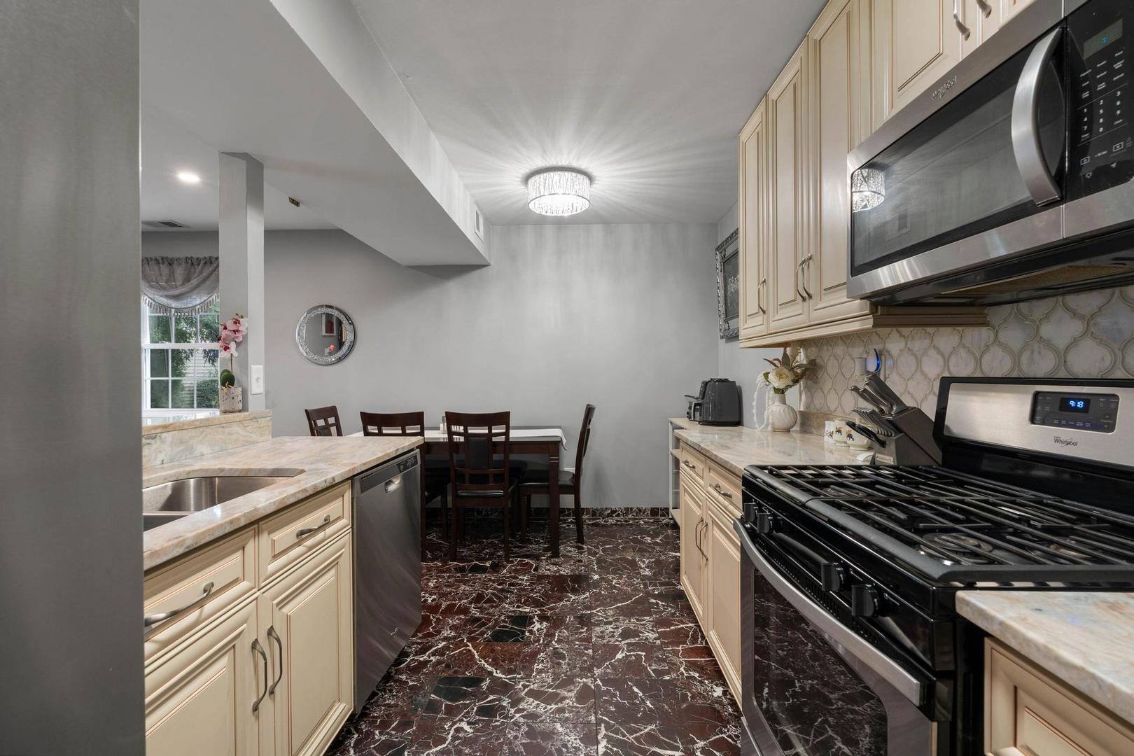 1312 Fall Court, Unit 1312 Wheeling, IL 60090 - Photo 10 of 28 a kitchen with a stove and a sink