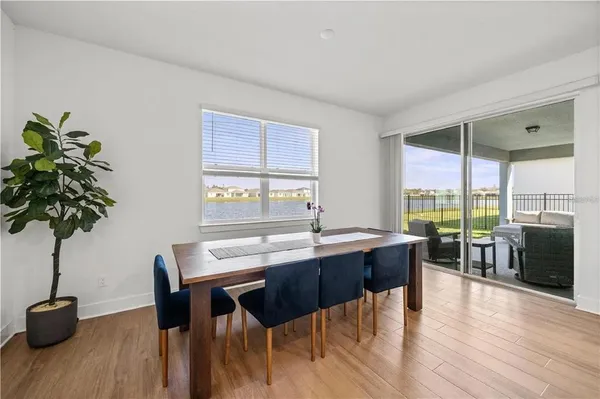 a dining room with furniture window and wooden floor