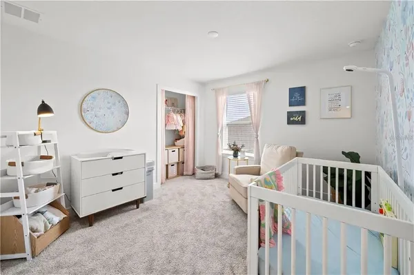 a bedroom with furniture and a window