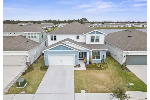 an aerial view of a house with a yard