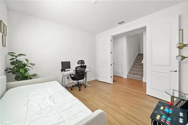 a bed room with a bed and a chair