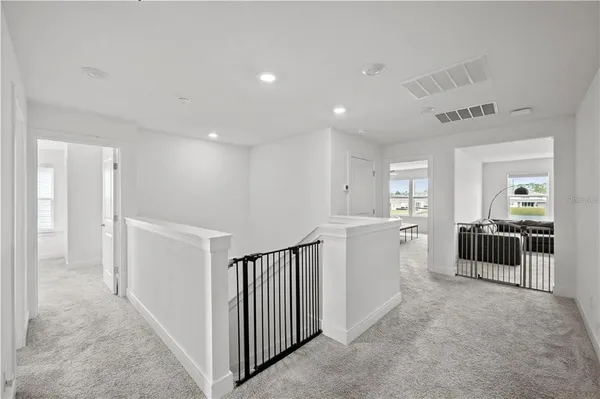 a view of a hallway with dining room and kitchen