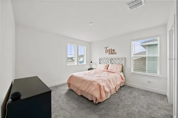 a bedroom with a bed lamps and window