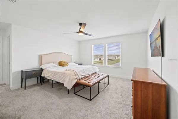 a bedroom with a bed and a dresser