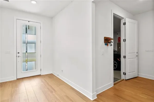 an empty room with wooden floor and closet