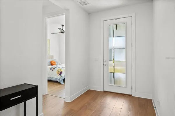 an empty room with wooden floor and closet
