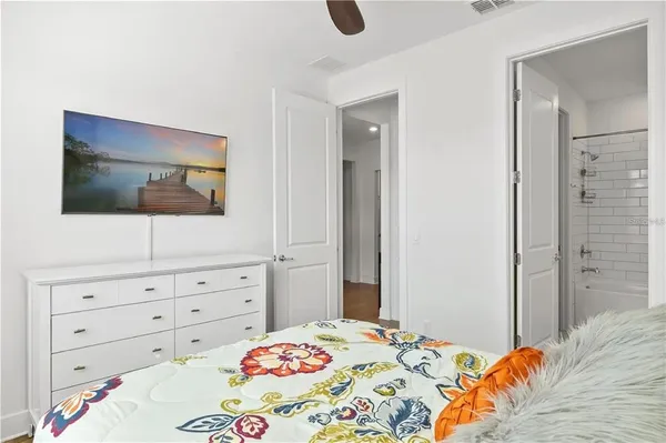 a bedroom with a bed and a flat screen tv