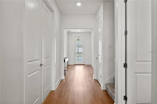 a view of a hallway with wooden floor
