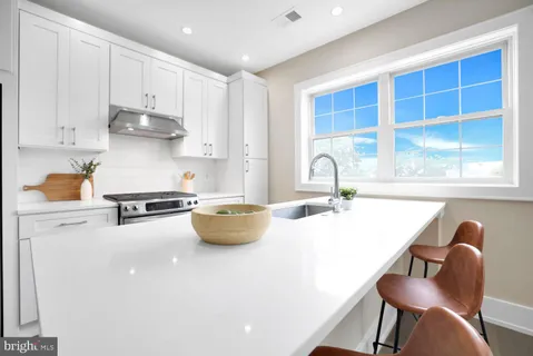 a kitchen with stainless steel appliances a sink and a stove