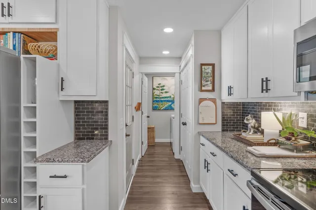 a bedroom with a bed chandelier and a window
