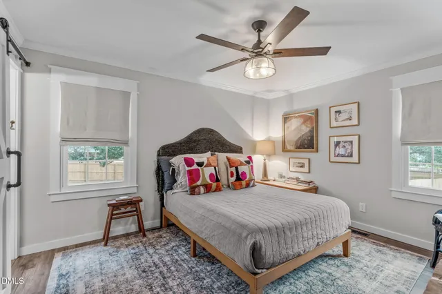 a bedroom with a bed and a chandelier
