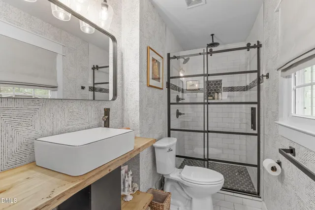 a view of a patio with a table and chairs next to a yard