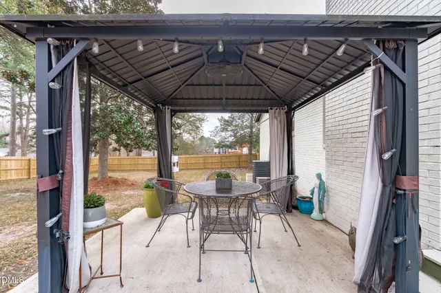 a front view of house with yard and trees around