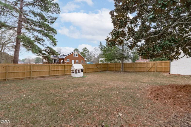 an aerial view of a house with outdoor space