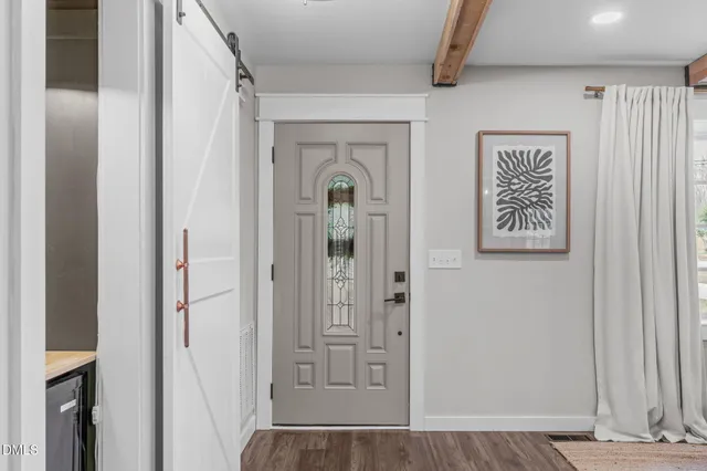 a view of a hallway with wooden floor and entryway
