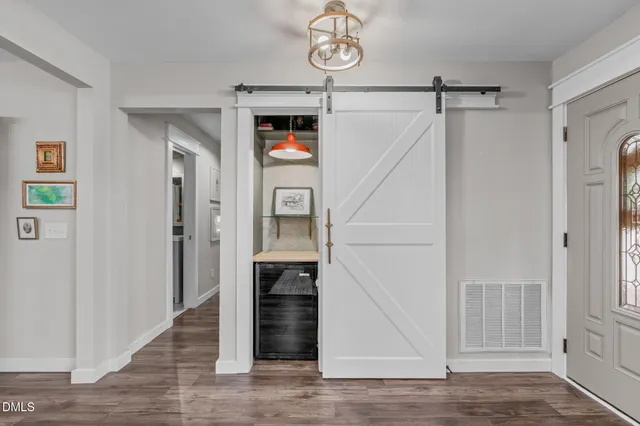 a view of a hallway with wooden floor and entryway