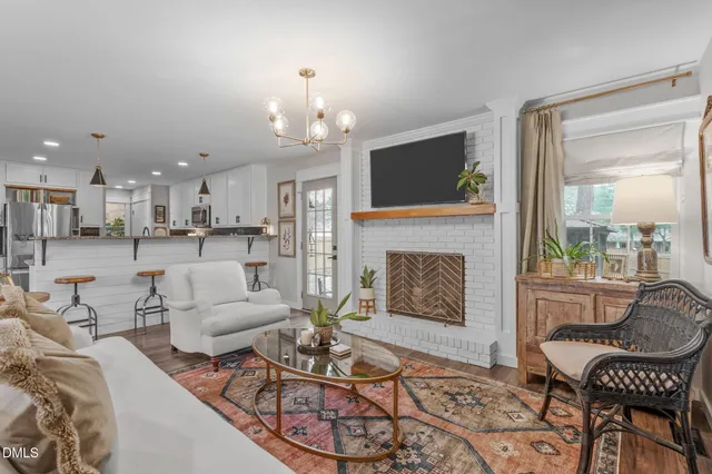 a living room with furniture and a chandelier