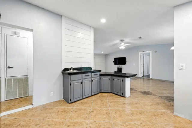 a large kitchen with stainless steel appliances granite countertop a stove and a sink