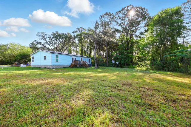 a view of a big yard with large trees