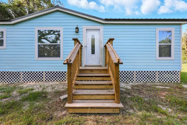 a front view of a house with wooden fence