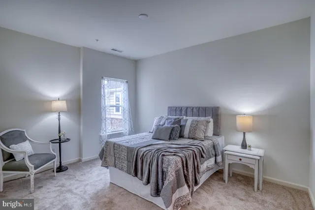 a bedroom with a bed and lamp