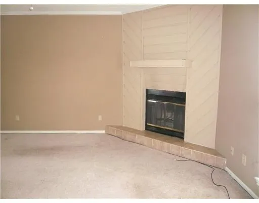a view of an empty room with a fireplace