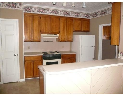 3051 Quail Springs Road, Unit B5 Corpus Christi, TX 78414 - Photo 4 of 7 a kitchen with stainless steel appliances granite countertop a refrigerator a stove and a sink