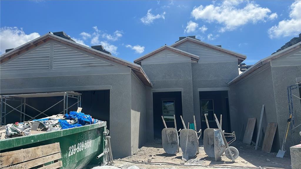 9052 Mayreau Way Naples, FL 34114 - Photo 1 of 2 a front view of a house with outdoor seating