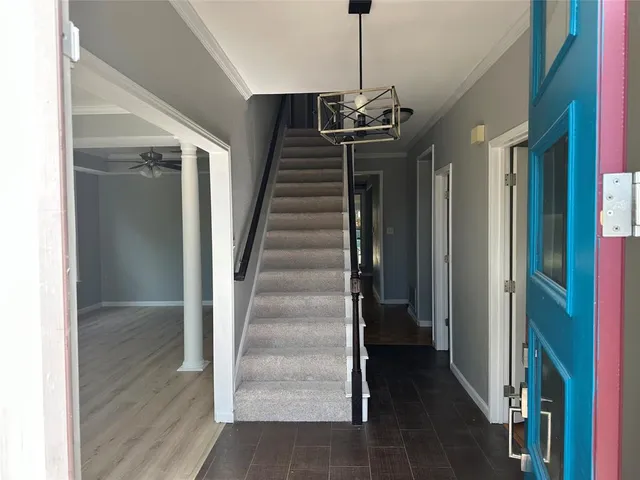 a view of a hallway with a chandelier and entryway