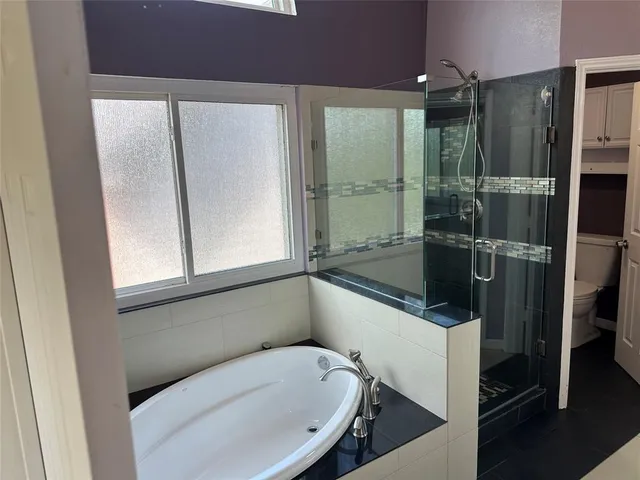 a bathroom with a glass shower door and a sink