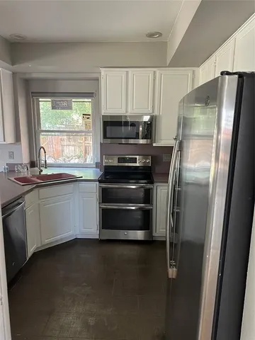 a kitchen with a refrigerator and a sink