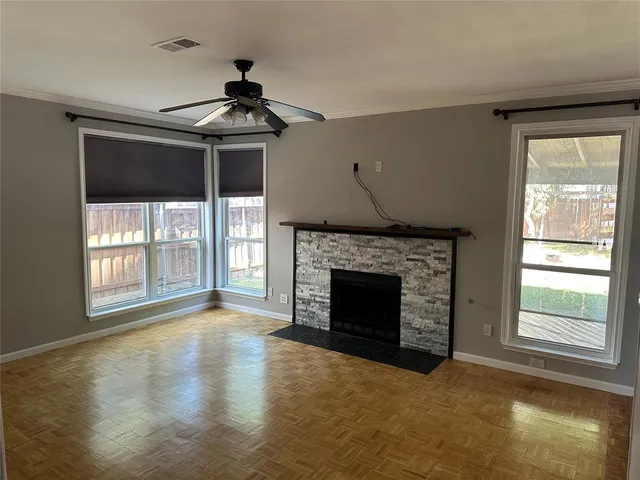 a big room with fireplace windows and a chandelier