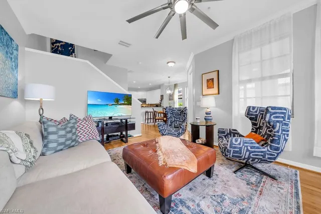a living room with furniture a table and a chandelier