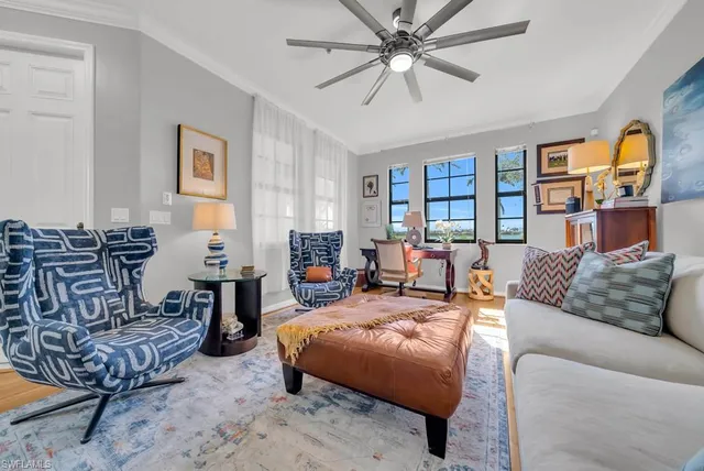 a living room with furniture fireplace and a window